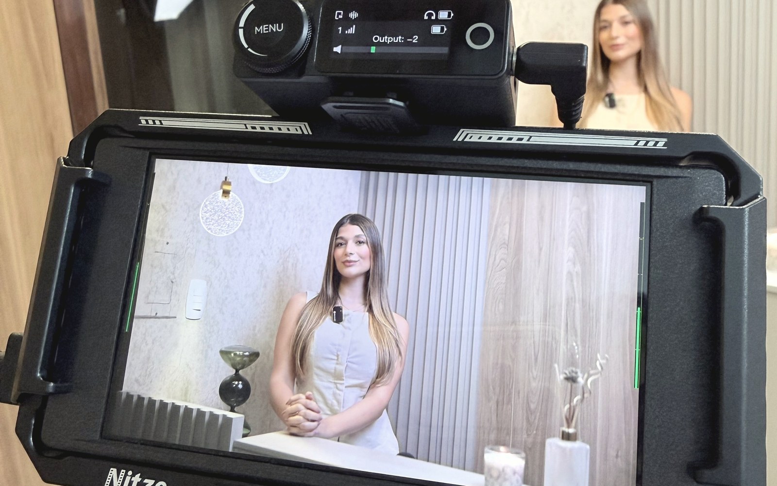 Camera and external monitor framing a subject during a shoot